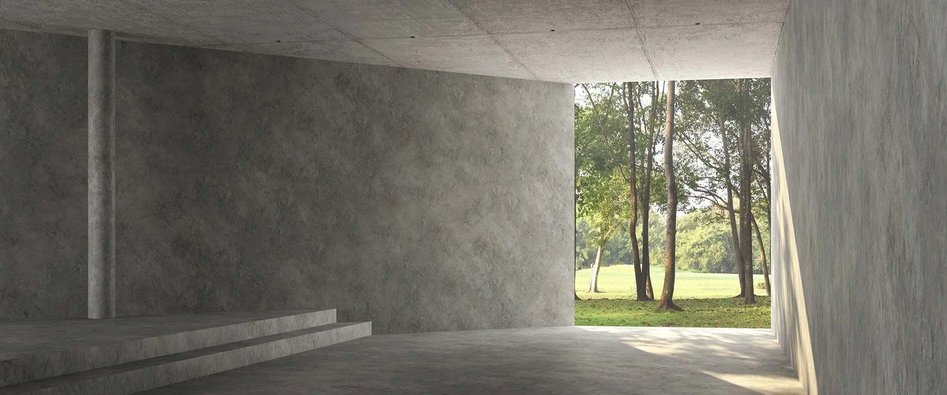 Smooth concrete walls and floor in an open room overlooking trees